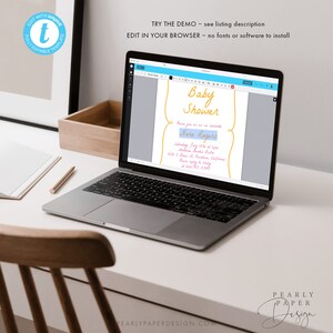 May include: A laptop computer displaying a baby shower invitation template on the screen. The invitation is light blue with yellow text and a pink border. The text on the invitation reads "Baby Shower" and "Nora Rogers".