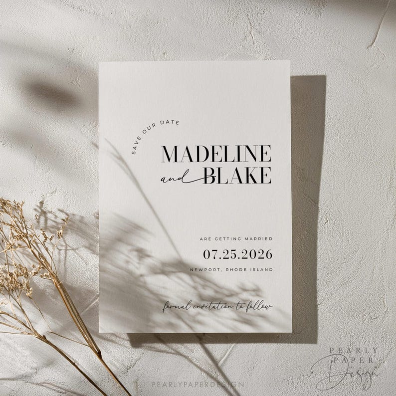 May include: A minimalist save the date card with a white background and black text. The text reads "Save Our Date" in a circle, followed by "Madeline and Blake" in a bold font. The date "07.25.2026" is printed below, along with the location "Newport, Rhode Island". The text "formal invitation to follow" is written in cursive at the bottom.