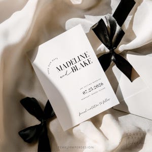 May include: A white save the date card with black text. The text reads "Save Our Date" and "Madeline and Blake are getting married 07.25.2026 Newport, Rhode Island formal invitation to follow".