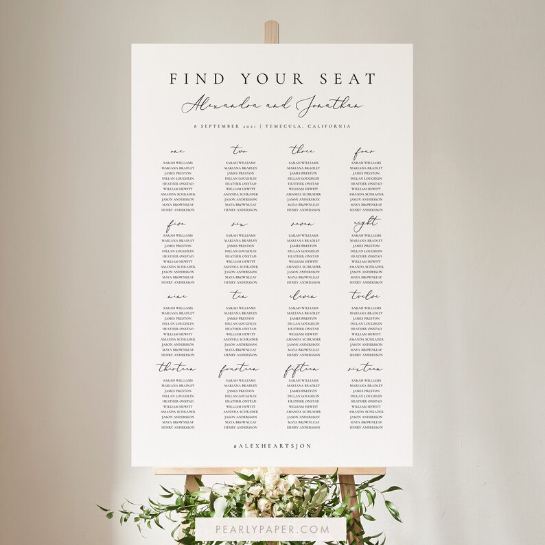 May include: A white wedding seating chart with the text "Find Your Seat" at the top. The names "Alexandre and Jonathen" are written in cursive below the title. The date "8 September 2021" and location "Temecula, California" are listed below the names. The chart is divided into 16 columns, each with a table number and a list of names.