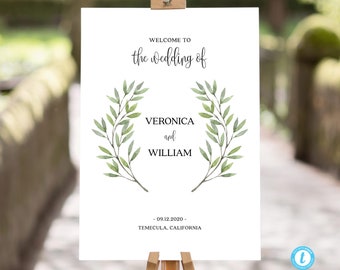 May include: A white wedding welcome sign with a green leafy wreath and the text "Welcome to the wedding of Veronica and William - 09.12.2020 - Temecula, California"