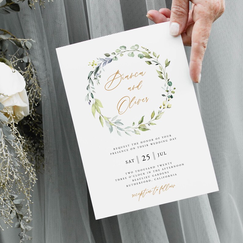 May include: A wedding invitation with a watercolor wreath of green leaves and white flowers. The invitation is for Bianca and Oliver's wedding on Saturday, July 25th at 3:00 PM at Beaulieu Gardens in Rutherford, California.