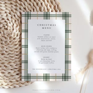 May include: A Christmas menu card with a green and white plaid pattern. The menu includes starter, main course, and dessert options. The text reads "Christmas Menu", "Starter", "Smoked salmon on toast with mayonnaise, caviar, lemon and dill", "Main Course", "Roast turkey with cranberry, chestnut and sage stuffing, served with gravy mashed potato", "Dessert", "B&uuml;che de No&euml;l", "Triple-Chocolate Trifle", "Gingerbread Truffles", and "The Henderson's Christmas 2024".