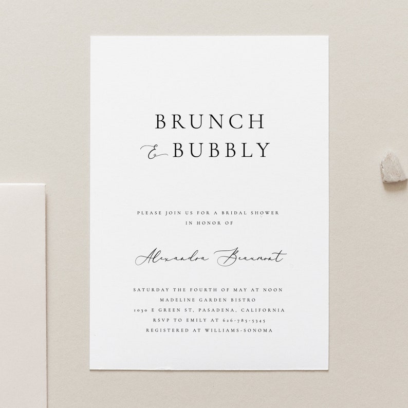 May include: A white invitation card with black text announcing a bridal shower for Alexandre Beaumont. The event is called "Brunch & Bubbly" and will be held at Madeline Garden Bistro on Saturday, May 4th at noon. The address is 1030 E Green St, Pasadena, California. RSVP to Emily at 636-785-5345. The event is registered at Williams-Sonoma.