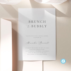 May include: A white bridal shower invitation with black text. The invitation reads "BRUNCH & BUBBLY" and includes the details for a bridal shower for Alexandre Buenont. The shower will be held on Saturday, May 4th at noon at Madeline Garden Bistro in Pasadena, California.
