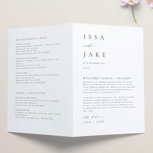 May include: A white wedding invitation with a simple design. The invitation features the names "ISSA and JAKE" in a modern font, along with the wedding date, "24-26 SEPTEMBER 2021". The invitation also includes a welcome message for guests, inviting them to celebrate the couple's wedding weekend at Belcourt Castiel.