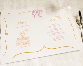 May include: A wedding menu with a gold border and pink accents. The menu includes a starter, entree, and dessert. The text reads "Hello! We're so glad you're here." and "Menu".