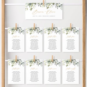 May include: Eight table cards with a green and white floral design and gold lettering. Each card has a table number and a list of names. The cards are labelled "table one" through "table eight".