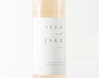 May include: White wine bottle with a personalized label that reads "Issa and Jake" with the date "25 September 2021" and the location "Belcourt Castle".