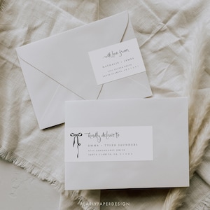 May include: Two white envelopes with handwritten address labels. The top envelope says "with love from Nathalie James 1581 Seezer Drive Santa Clarita, CA 91351". The bottom envelope says "kindly deliver to Emma Tyler Saunders 4745 Sandhearst Drive Santa Clarita, CA 91383".