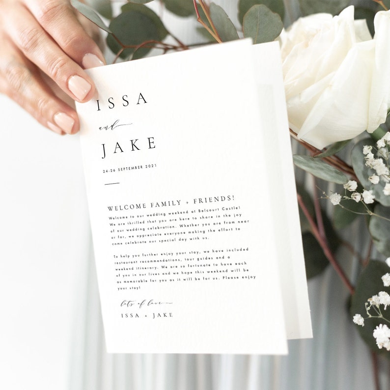 May include: A white wedding invitation card with black text. The card reads "ISSA and JAKE 24-26 SEPTEMBER 2021 WELCOME FAMILY & FRIENDS!" and includes a message welcoming guests to the wedding weekend at Belcourt Castle.