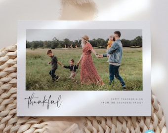 May include: A Thanksgiving card with a photo of a family of five walking in a field. The card says "Thankful" and "Happy Thanksgiving from the Saunders Family".