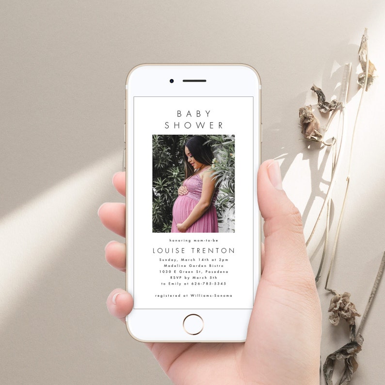May include: A white smartphone displaying a baby shower invitation for Louise Trenton. The invitation includes the date, time, location, and RSVP information. A photo of the expectant mother is featured on the invitation.
