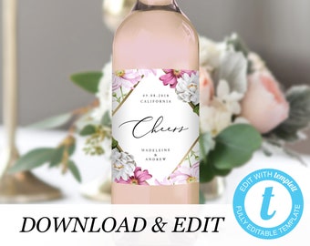 Può includere: Un'etichetta per bottiglia di vino da matrimonio stampabile con un design floreale in tonalità di rosa e bianco. L'etichetta presenta una cornice geometrica dorata e il testo "Cheers, Madeleine & Andrew, 09.08.2018, California".
