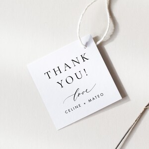 May include: White square thank you tag with black text that reads "Thank You!" and "love Celine + Mateo".