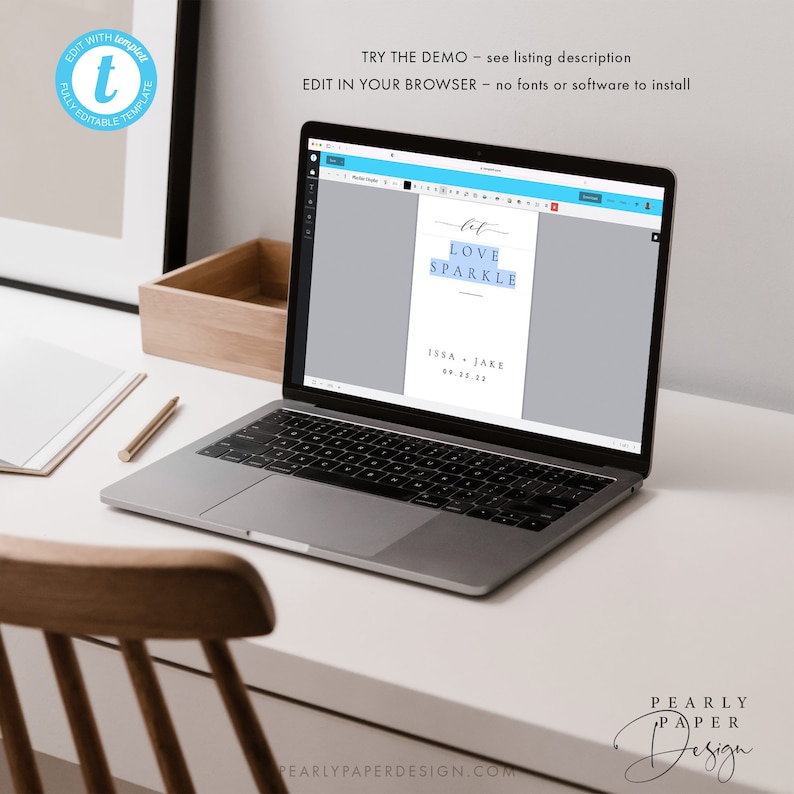 May include: A laptop displaying a wedding invitation template with the words "Let Love Sparkle." The design includes the names Issa and Jake, along with the date 09.23.22. The laptop is on a white desk with a wooden box and a pen.
