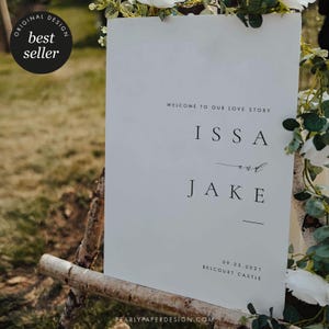 May include: White wedding sign with black text that reads "Welcome to our love story, Issa and Jake, 09.25.2021, Belcourt Castle".