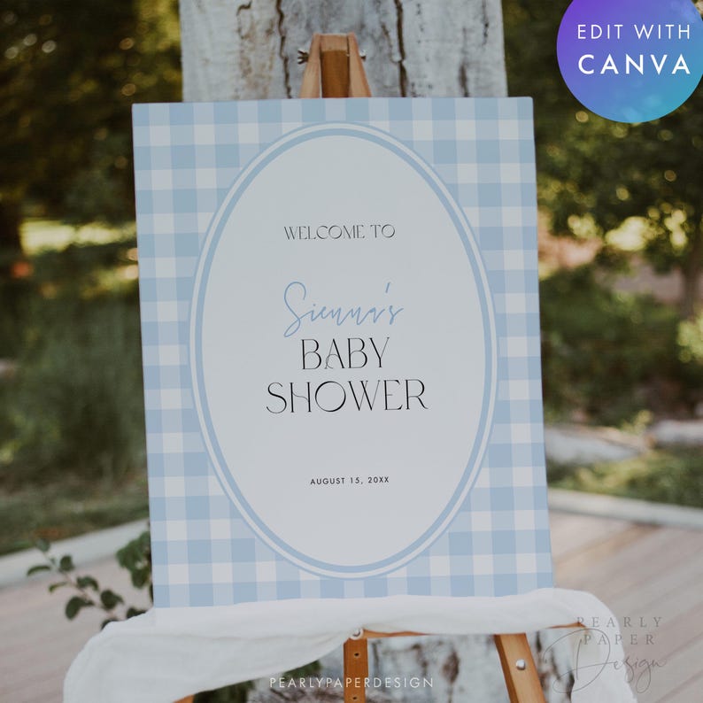 May include: A baby shower sign on an easel. The sign has a light blue gingham pattern background with a white oval in the center. The text reads "WELCOME TO Sienna's BABY SHOWER" and "AUGUST 15, 20XX".
