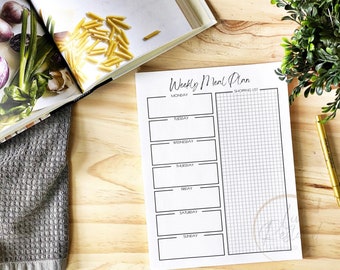 May include: A printable weekly meal planner with a blank space for each day of the week and a gridded section for a shopping list. The text "Weekly Meal Plan" is at the top of the page.