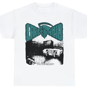 May include: White t-shirt with a black and white graphic print of a car, a building, and a skull. The text "CARB-NIZED" is printed in teal above the graphic. The text "FOR THE SECURITY" is printed below the graphic.
