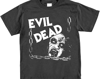 May include: Black t-shirt with a white graphic of a zombie face and the text "Evil Dead" on the front.