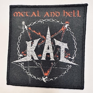 May include: Black square patch with the words "METAL AND HELL" in orange above a white and orange pentagram with the word "KAT" in white. A chain surrounds the pentagram.