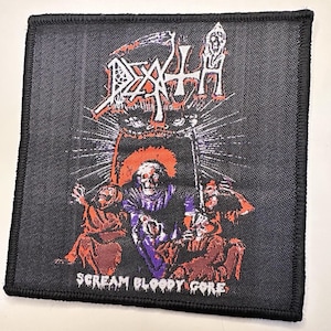 May include: Black square patch with a Death metal band design. The patch features the band's logo in white and red, with a grim reaper figure and the text "SCREAM BLOODY GORE". The design includes figures in red and purple.
