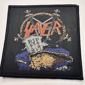 May include: A white ceramic mug with a black handle and the text "But First, Coffee" in a bold, black font. The mug is set against a neutral background, highlighting its simple design.