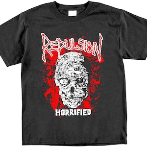 May include: Black t-shirt with a white graphic of a skull with the text "Repulsion" and "Horrified" in red.