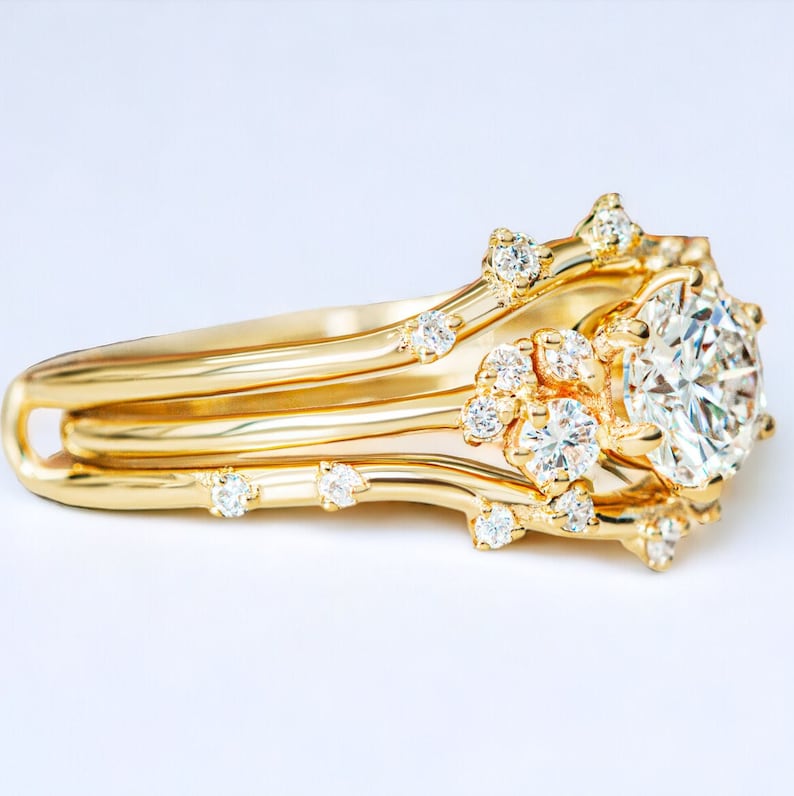 May include: A gold ring with a large, round diamond surrounded by smaller diamonds. The ring band is made of three thin bands of gold that are intertwined.