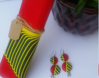 May include: A pair of earrings with two round, red and yellow patterned fabric discs on each earring. The earrings have a silver hook and dangle with three small silver beads.