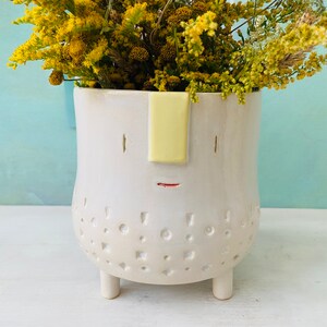 Flower pot with a cute face on four feet in white, bulbous shape, hand-made ceramic with stamped pattern, unique