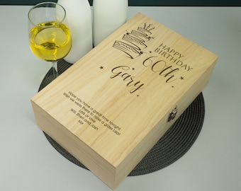 May include: A wooden box with a hinged lid, engraved with the text "Happy Birthday 60th Gary." The box is decorated with a cake design and stars. The text "Hope you have a great time tonight. Wish we were there to raise a glass Lisa! Lots of love Will, Sherl and Josh xxx" is also engraved on the box.