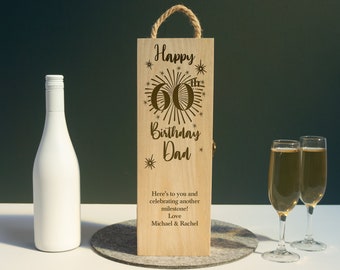 May include: Wooden wine bottle gift box with a personalized message for a 60th birthday. The box is decorated with a gold 60th birthday design and the words "Happy 60th Birthday Dad". The message on the box reads "Here's to you and celebrating another milestone! Love, Michael & Rachel".