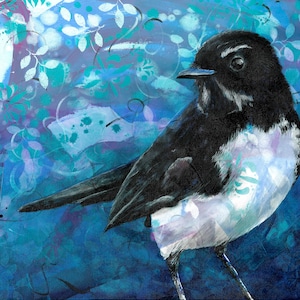 May include: A black and white bird with a white breast and a black head and wings. The bird is perched on a blue and purple background with white and green floral patterns.