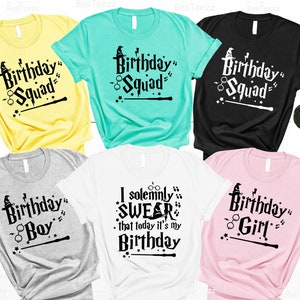 May include: Six different t-shirts with a Harry Potter theme. The shirts are in various colors, including yellow, teal, black, gray, white, and pink. The shirts feature text that says "Birthday Squad", "Birthday Boy", "Birthday Girl", and "I solemnly swear that today it's my birthday".