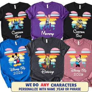 May include: A collection of six colorful t-shirts featuring Disney characters. Each shirt has a Mickey Mouse head design with a character image and text. The shirts are black, purple, blue, gray, and pink. The text includes "Custom Text", "Mommy", "Daddy", and "Disney Trip 2026".