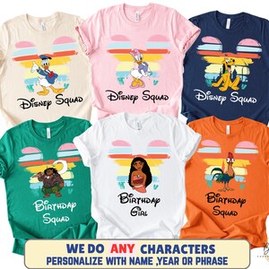 May include: A collection of colorful t-shirts featuring Disney characters. Each shirt displays a character like Donald Duck, Daisy Duck, Pluto, Moana, and Hei Hei. The shirts have the words "Disney Squad" or "Birthday Squad" printed on them.