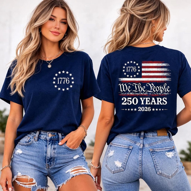 May include: A navy blue t-shirt featuring a white circular star design with the text 1776 on the front. The back displays a distressed American flag graphic, the text We The People, 250 YEARS, and 2026, all printed in white and red.