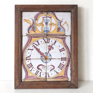 May include: A framed vintage clock design. The clock face features Roman numerals and ornate hands, with a decorative top including an hourglass and scythe. The color palette includes white, yellow, red, and blue, set within a dark brown wooden frame.