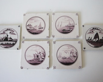 May include: A collection of six square ceramic tiles with sepia-toned landscape scenes. Each tile features a circular design with images of boats, buildings, and water. The tiles are arranged on a white surface.