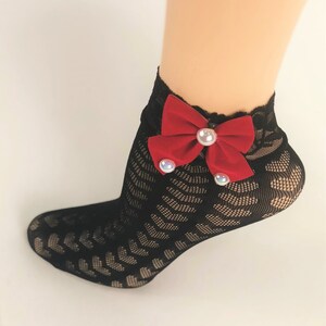 May include: Black lace ankle socks with a red velvet bow and pearl embellishments.