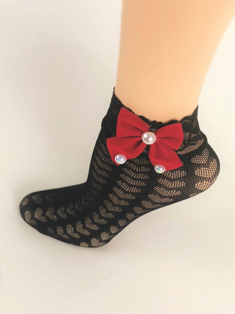 May include: Black lace ankle socks with a red velvet bow and pearl embellishments.