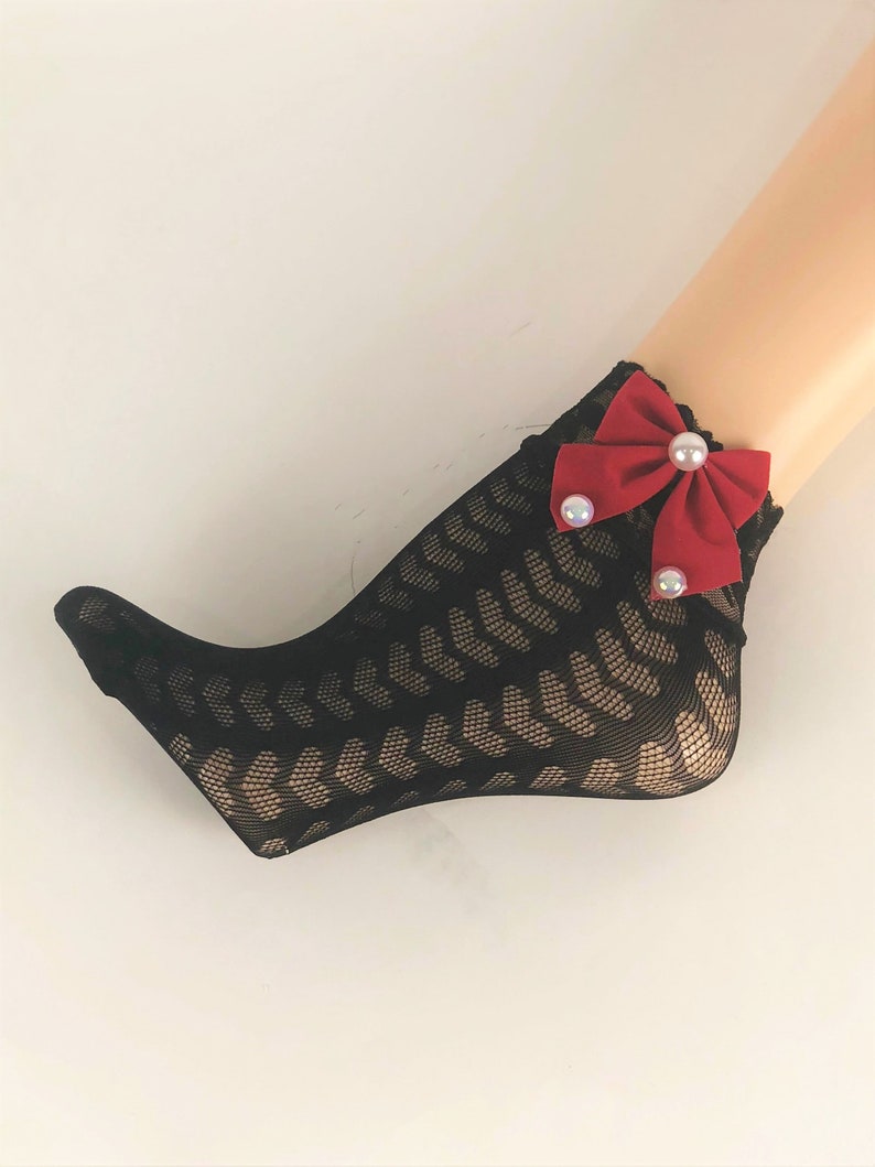 May include: Black fishnet socks with a red bow and pearl embellishments.