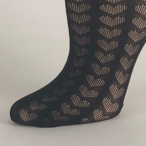 May include: Black fishnet tights with a geometric pattern. The tights are opaque and have a subtle sheen.