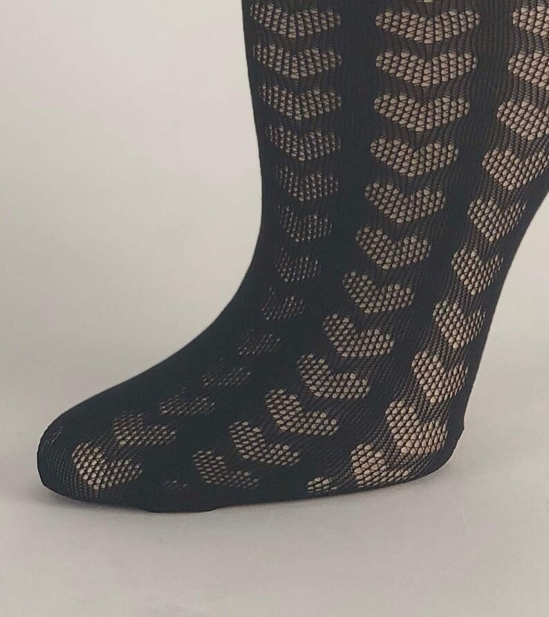 May include: Black fishnet tights with a geometric pattern. The tights are opaque and have a subtle sheen.