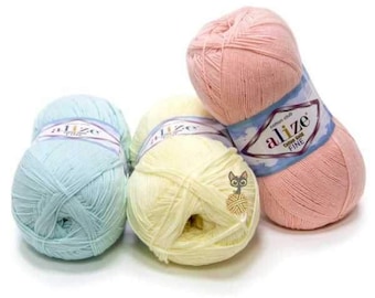 May include: Three balls of yarn in pastel colors: light blue, yellow, and pink. Each ball has a label that says "alize Cotton Gold Fine".