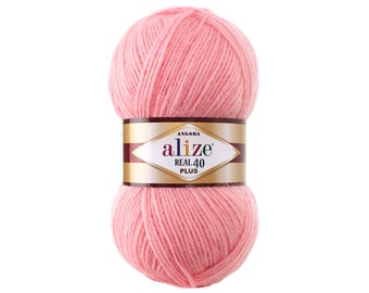 Puede incluir: Un ovillo de lana rosa con la etiqueta "alize REAL 40 PLUS ANGORA"