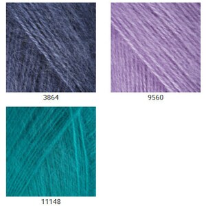 May include: Six yarn skeins in different colors: light blue, dark blue, light purple, dark purple, pink, and teal.
