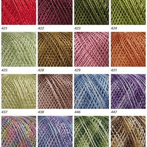May include: A collection of 16 skeins of metallic yarn in various colors, including red, green, gold, pink, blue, and purple. Each skein is labeled with a number from 421 to 454.